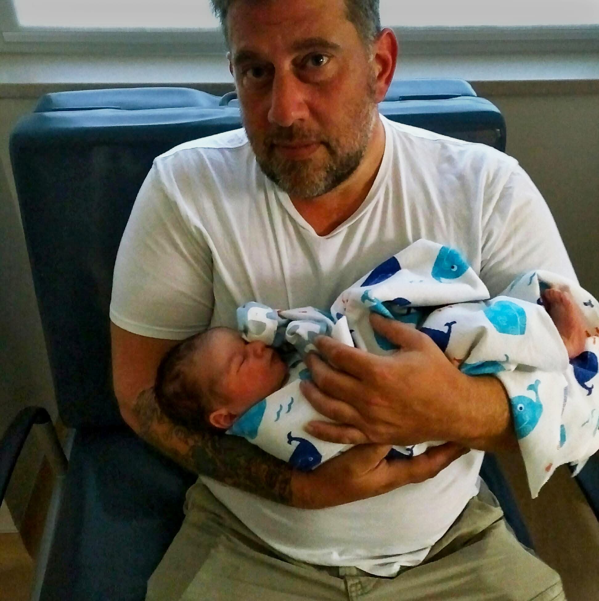 Loren holding a newborn baby
